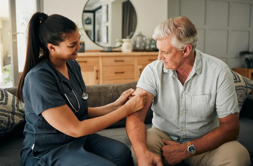 Nurse providing medical treatment to patient during home detox care