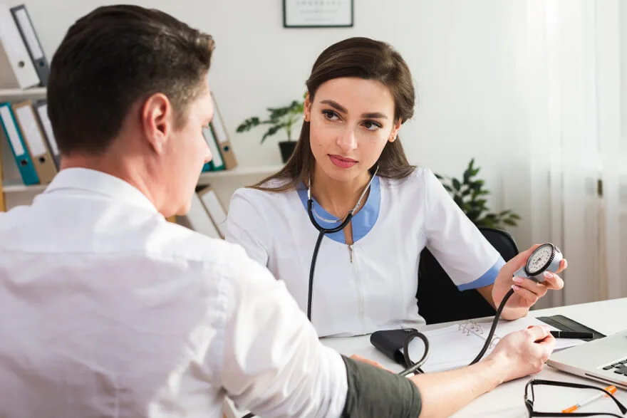 Medical Monitoring During Drug Detox Healthcare professional checking patient vitals during drug detox treatment