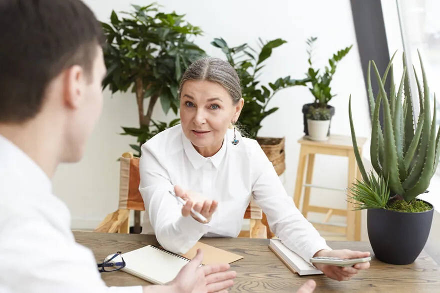 Rehabilitation Consultation Session with Advisor Advisor discussing rehabilitation options with a patient in a calm professional setting